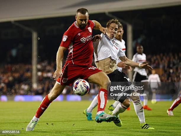 Stefan Johansen of Fulham closes down Aaron Wilbraham of Bristol City during the EFL Cup Third Round match between Fulham and Bristol City at Craven...