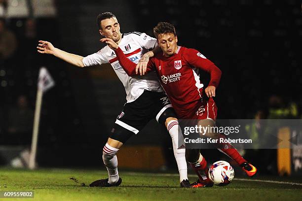 Luke Freeman of Bristol City holds off the challenge of Scott Malone of Fulham during the EFL Cup Third Round match between Fulham and Bristol City...