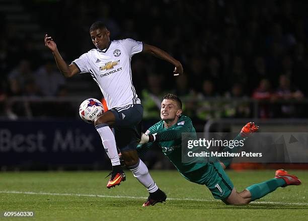 Marcus Rashford of Manchester United goes past Adam Smith of Northampton to score his team's third goal during the EFL Cup Third Round match between...