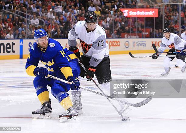 Mattias Ekholm of Team Sweden battles for the puck with Johnny Gaudreau of Team North America during the World Cup of Hockey 2016 at Air Canada...