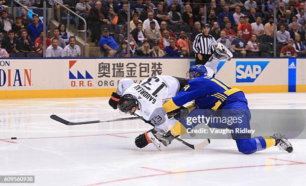 Johnny Gaudreau of Team North America collides with Mattias Ekholm of Team Sweden during the World Cup of Hockey 2016 at Air Canada Centre on...