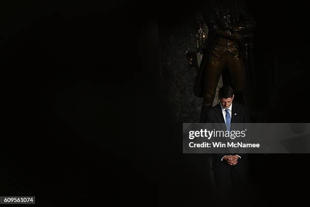 Speaker of the House Paul Ryan bows his head in prayer during the invocation for a ceremony to dedicate a statue of Thomas Edison in Statuary Hall at...