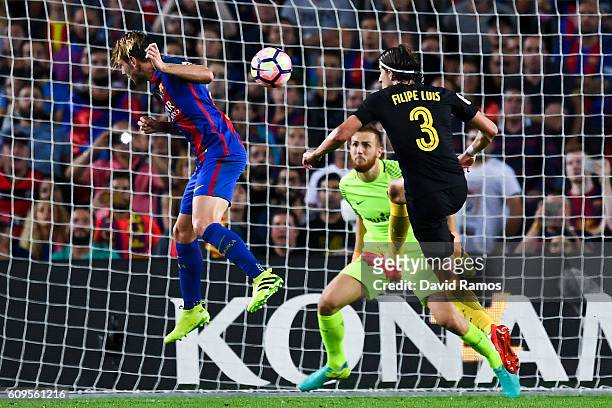 Ivan Rakitic of FC Barcelona scores the opening goal past Filipe Luis and the goalkeeper Jan Oblak of Club Atletico de Madrid during the La Liga...