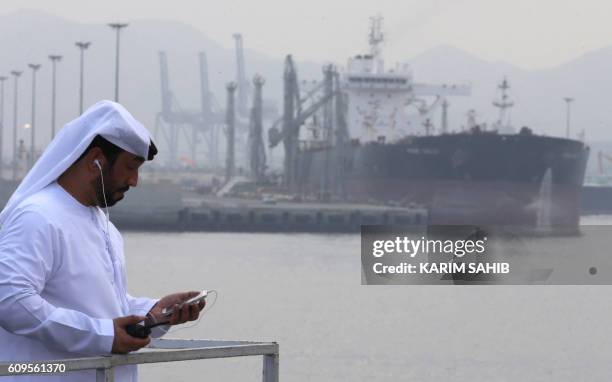 An Emirati man stands at the oil terminal of Fujairah during the inauguration ceremony of a dock for supertankers on September 21, 2016. - The oil...