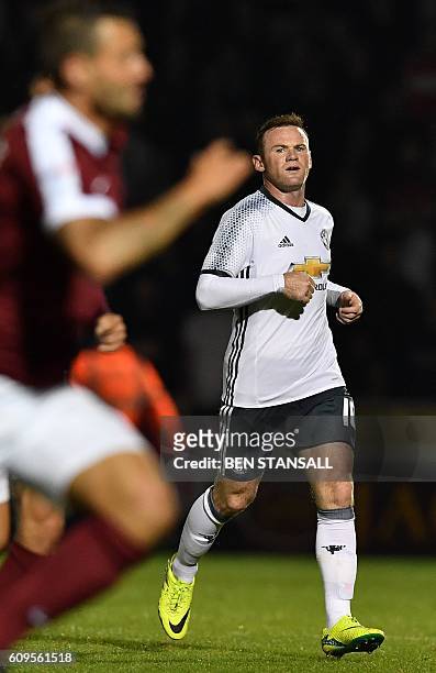Manchester United's English striker Wayne Rooney reacts during the English League Cup third round football match between Northampton Town and...