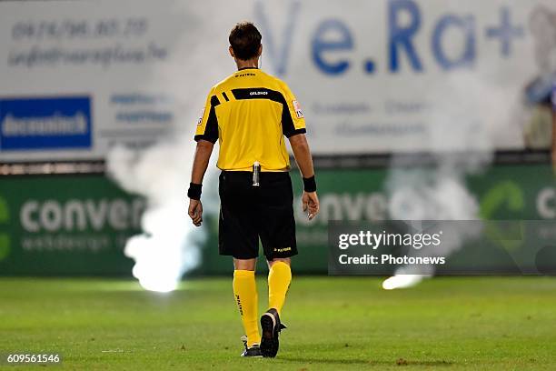 Referee Frederik Geldhof pictured in front of some firework during the Croky Cup 1/16 final match between SC Eendracht Aalst and KRC Genk in the...