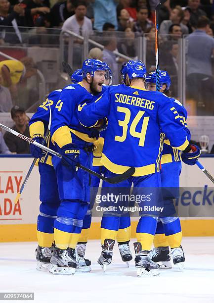 Mattias Ekholm and Carl Soderberg celebrate after Team Sweden scores a third period goal on Team North America during the World Cup of Hockey 2016 at...