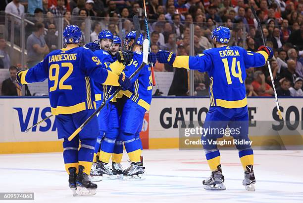 Patrik Berglund celebrates with Gabriel Landeskog, Erik Karlsson, Carl Soderberg and Mattias Ekholm of Team Sweden after scoring a third period goal...