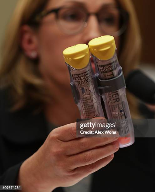 Mylan Inc. CEO Heather Bresch holds up a 2-pack of EpiPen as she testifies during a hearing before the House Oversight and Government Reform...