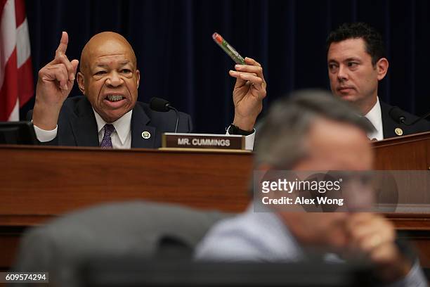 Ranking member Rep. Elijah Cummings holds up an EpiPen as he speaks as committee chairman Rep. Jason Chaffetz looks on during a hearing before the...