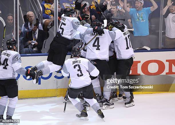Nathan MacKinnon of Team North America is congratulated by teammates after scoring a game-winning goal in overtime against Team Sweden during the...