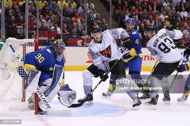 Nathan MacKinnon of Team North America battles for position with Niklas Hjalmarsson in front of Henrik Lundqvist of Team Sweden during the World Cup...