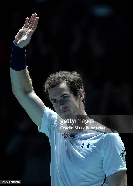 Andy Murray of Scotland waves to the crowd during the doubles match between Andy Murray and Jamie Murray of Scotland and Tim Henman of England and...