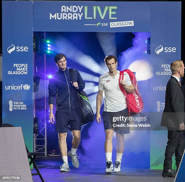 Jamie Murray and Andy Murray walk onto court before their doubles match with Tim Henman and Grigor Dimitrov during Andy Murray Live presented by SSE...