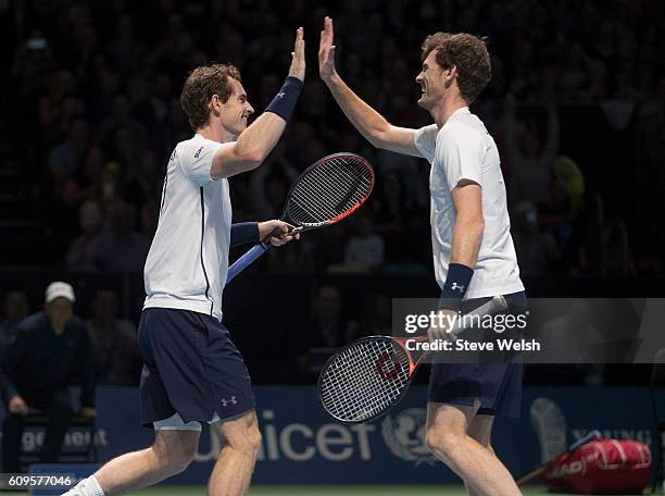 Andy Murray and Jamie Murray celebrates a point against Tim Henman and Grigor Dimitrov during Andy Murray Live presented by SSE at the SSE Hydro on...