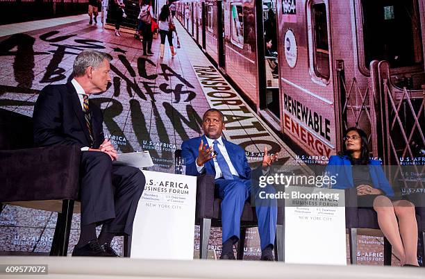 Aliko Dangote, president and chief executive officer of Dangote Sugar Refinery Plc, center, speaks as Jasandra Nyker, chief executive officer of...