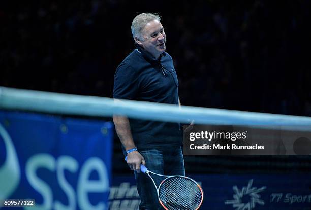 Ex Scottish football player Ally McCoist replaces Andy Murray of Scotland during the doubles match between Andy Murray and Jamie Murray of Scotland...