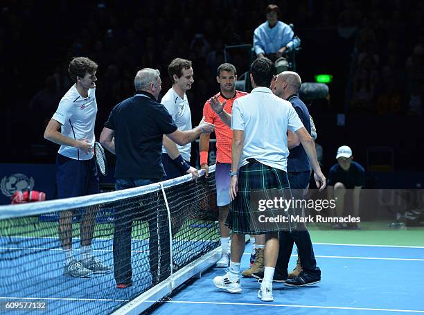 Competitors shake hands at the end of the doubles match between Andy Murray and Jamie Murray of Scotland and Tim Henman of England and Grigor...
