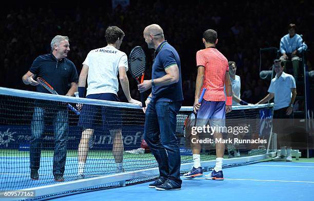 Competitors shake hands at the end of the doubles match between Andy Murray and Jamie Murray of Scotland and Tim Henman of England and Grigor...