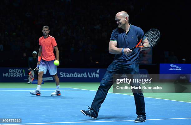 Ex Scottish Rugby player Gregor Townsend , replaces Tim Henman of England during the doubles match between Andy Murray and Jamie Murray of Scotland...