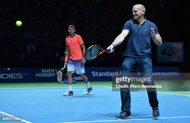 Ex Scottish Rugby player Gregor Townsend , replaces Tim Henman of England during the doubles match between Andy Murray and Jamie Murray of Scotland...