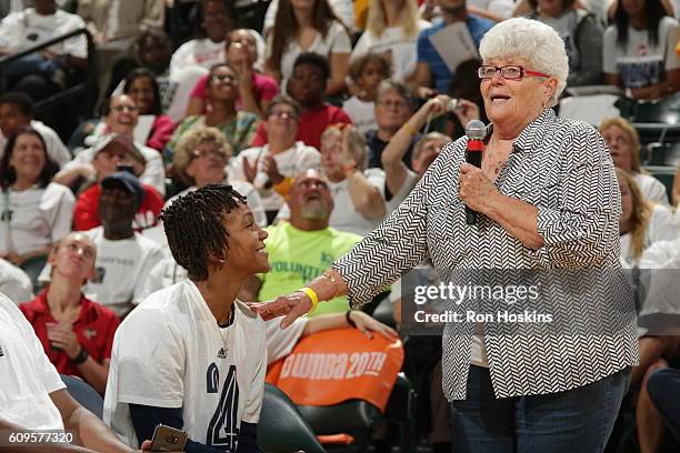 Former Fever coach Lin Dunn honors Tamika Catchings of the Indiana Fever during a ceremony after the game against the Dallas Wings at Bankers Life...