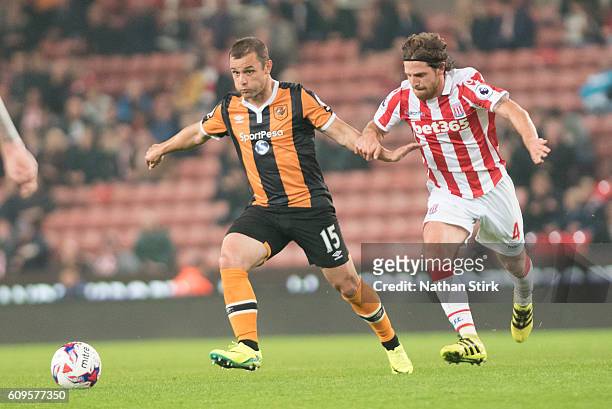 Shaun Maloney of Hull and Joe Allen of Stoke City in action during the EFL Cup Third Round match between Stoke City and Hull City at the Bet365...