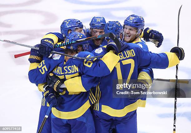 Patrik Berglund of Team Sweden celebrates his game-tying goal in the third period with teammates against Team North America during the World Cup of...