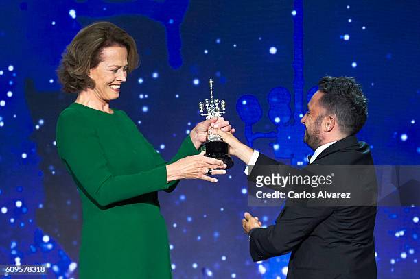 Actress Sigourney Weaver receives the Donostia award from director Juan Antonio Bayona during the 64th San Sebastian International Film Festival at...
