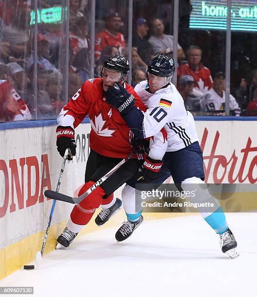 Jonathan Toews of Team Canada battles for the puck along the boards with Christian Ehrhoff of Team Europe during the World Cup of Hockey 2016 at Air...