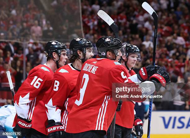 Jonathan Toews celebrates with Matt Duchene and Drew Doughty of Team Canada after scoring a first period goal Team Europe during the World Cup of...