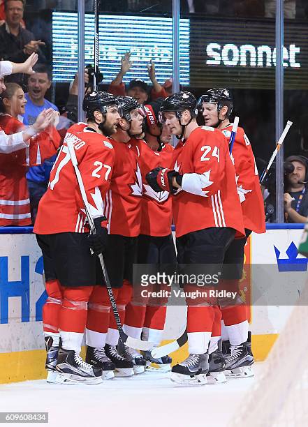 Jonathan Toews celebrates with Alex Pietrangelo, Corey Perry and Jay Bouwmeester of Team Canada after scoring a second period goal on Team Europe...