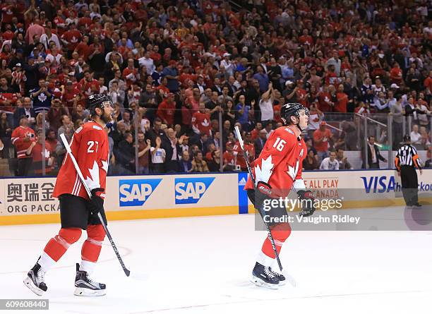 Jonathan Toews skates to the bench with Alex Pietrangelo of Team Canada after scoring a second period goal on Team Europe during the World Cup of...