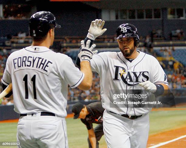 Left fielder Corey Dickerson of the Tampa Bay Rays celebrates with teammate second baseman Logan Forsythe after hitting a home run during the third...