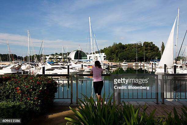 Woman looks out at yachts moored at Keppel Bay Marina in Singapore, on Sunday, Sept. 18, 2016. Singapore is currently mired in its most prolonged...