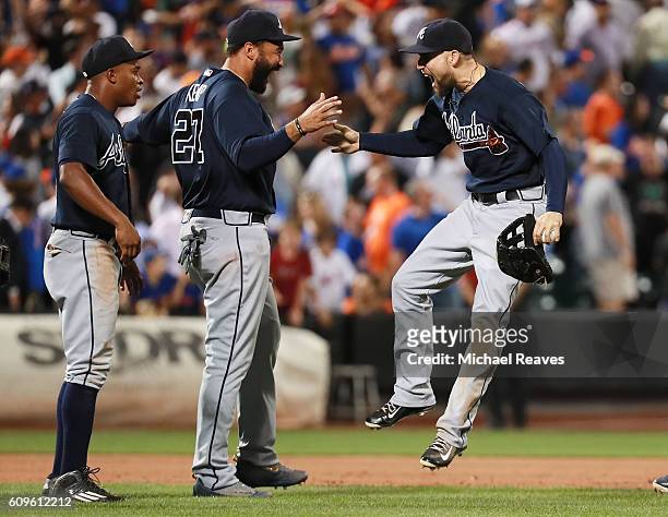 Ender Inciarte of the Atlanta Braves celebrates with Matt Kemp after he robbed a home run to end the game against the New York Mets at Citi Field on...