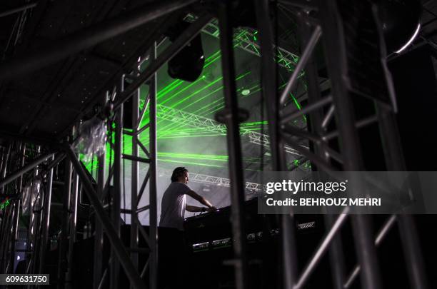 In this picture taken on September 19 Japanese DJ Ken Ishii performs during the Japan Ultra Music Festival at Odaiba Ultra Park in Tokyo. - A...