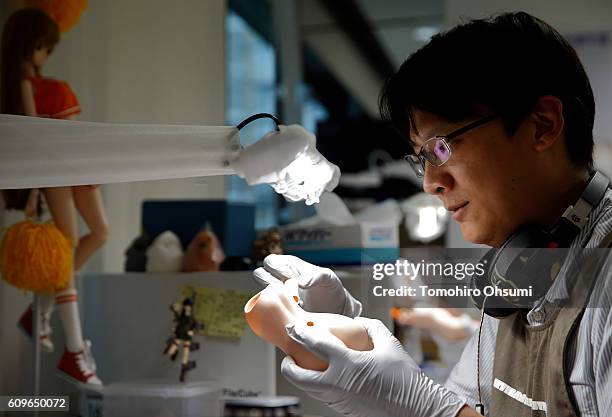 An employee checks a part of a smart doll at the Mirai Store Tokyo on August 22, 2016 in Tokyo, Japan. Isetan Mitsukoshi Holdings Ltd. Re-opens...