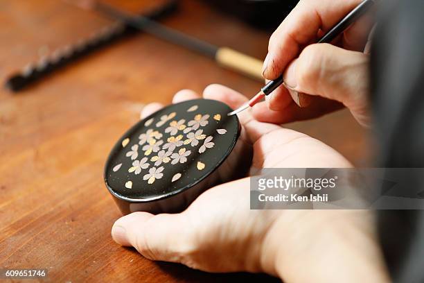 Lacquer artist and Japanese living national treasure Kazumi Murose paints on a lacquerware at the Mejiro Institute of Urushi Conservation on August...