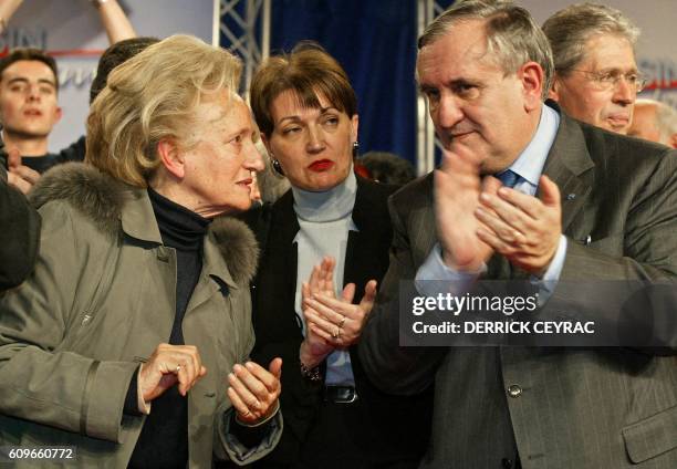 Prime Minister Jean-Pierre Raffarin and the wife of the president of the Republic Bernadette Chirac applaud the Marseillaise surrounded by...