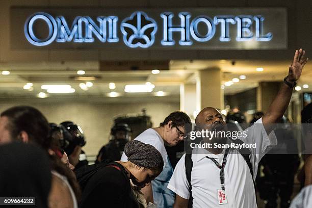 Demonstrator shouts about God's powers in front of the Omni Hotel September 22, 2016 in downtown Charlotte, NC. Protests in Charlotte began on...