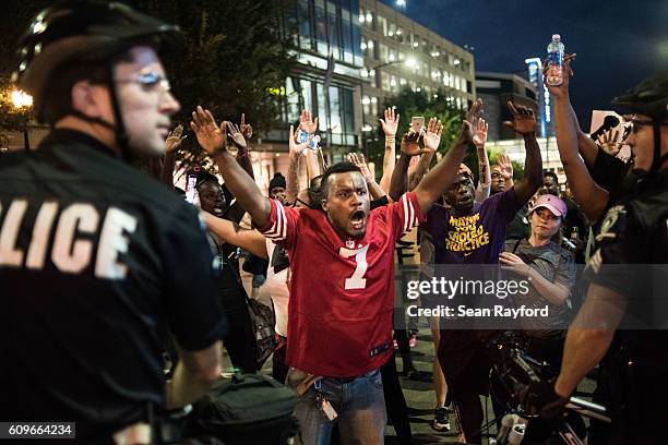 Protestors shout at police officers September 21, 2016 in Charlotte, NC. Protests in Charlotte began on Tuesday in response to the fatal shooting of...