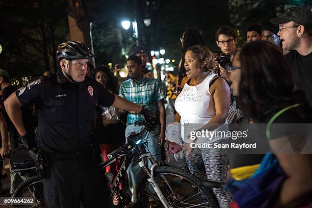Protestors question a police officer September 21, 2016 in Charlotte, NC. Protests in Charlotte began on Tuesday in response to the fatal shooting of...
