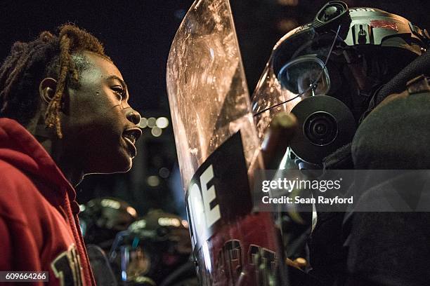 Demonstrator stares down law enforcement during protests September 21, 2016 in Charlotte, NC. Protests in Charlotte began on Tuesday in response to...