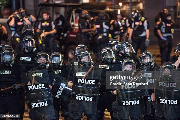 Police officers in riot gear hold their line September 21, 2016 in downtown Charlotte, NC. Protests in Charlotte began on Tuesday in response to the...