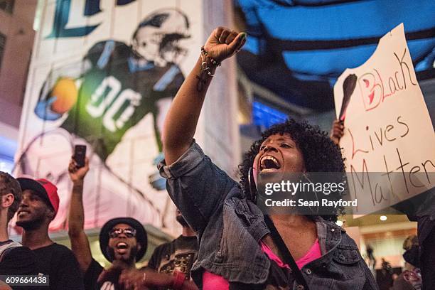 Demonstrator shouts while participating in protests September 21, 2016 in downtown Charlotte, NC. The North Carolina governor has declared a state of...