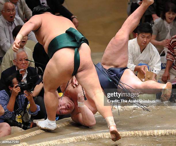 Okinoumi throws Mongolian yokozuna Kakuryu to win during day two of the Grand Sumo Autumn Tournament at Ryogoku Kokugikan on September 12, 2016 in...