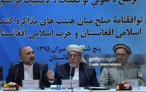 Afghan National Security Adviser, Hanif Atmar speaks as Chairman of The High Peace Council of Afghanistan, Pir Sayed Ahmed Gailani and Amin Karim,...