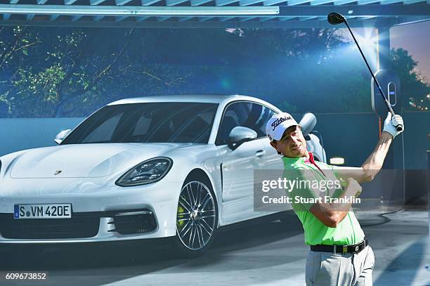 Brett Rumford of Australia stands infront of a Porsche advertising board during day one of the Porsche European Open at Golf Resort Bad Griesbach on...