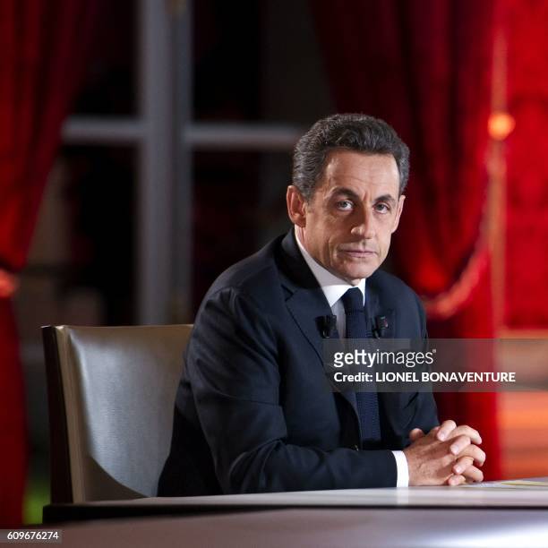 France's President Nicolas Sarkozy waits for the start of the one hour-long television interview with journalists Claire Chazal and Laurent...